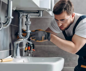 professional-plumber-clean-modern-bathroom-wearing-uniform-safety-gloves-carefully-inspecting-near-s